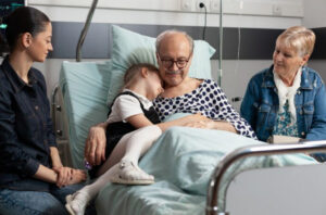 Family and hospice care coordinator talking at home about early hospice referral, symptom support, and care coordination for comfort-focused care